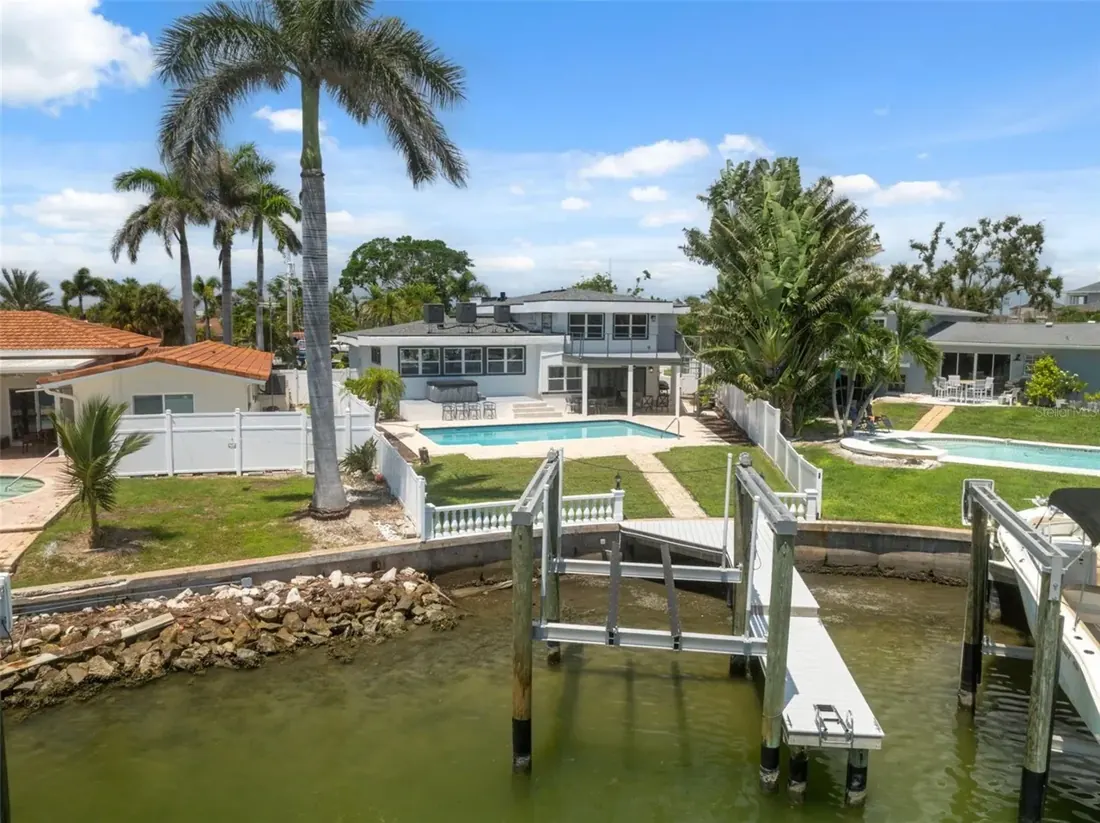Pool, dock, and boat lift with water view